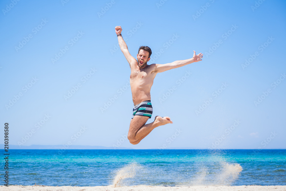 Happy traveler jumping happy at the beach, summer holiday