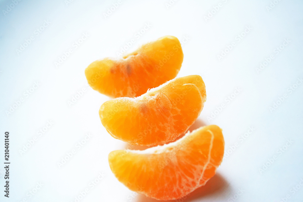 Slice of mandarin orange on white plate background Slice of mandarin orange on white plate background
