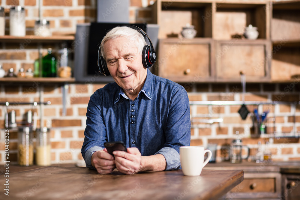 Nice elderly man listening to music