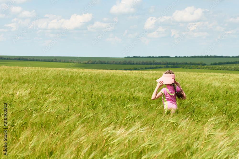 child walking through the wheat field, bright sun, beautiful summer landscape child walking through the wheat field, bright sun, beautiful summer landscape