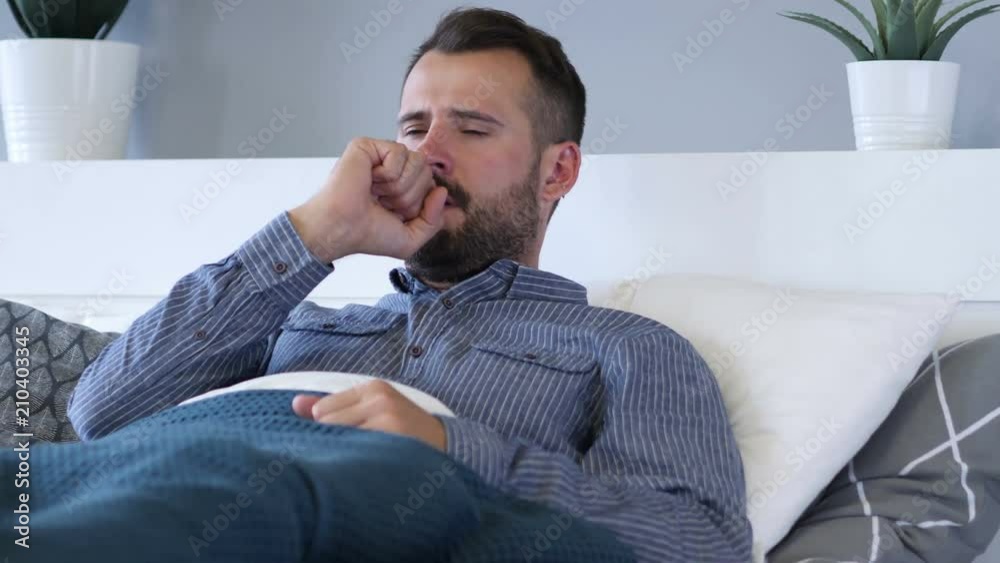 Sick Man Coughing while Lying in Bed Sick Man Coughing while Lying in Bed