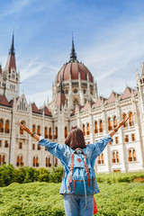 Happy asian casual woman student enjoying great view of the Parliament building in Budapest city, travel in Europe concept
