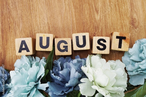 Photography august alphabet letter wooden cube with space copy on wooden background and flow