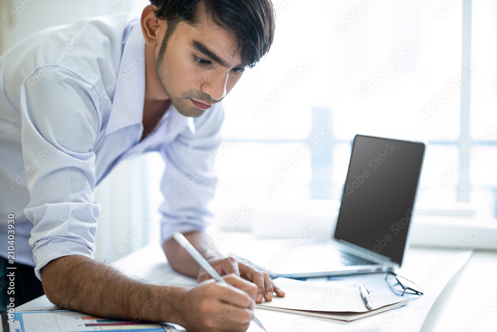 Business man working with laptop and documents Business man working with laptop and documents