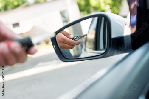 partial view of businessman with car key standing at car on street © LIGHTFIELD STUDIOS