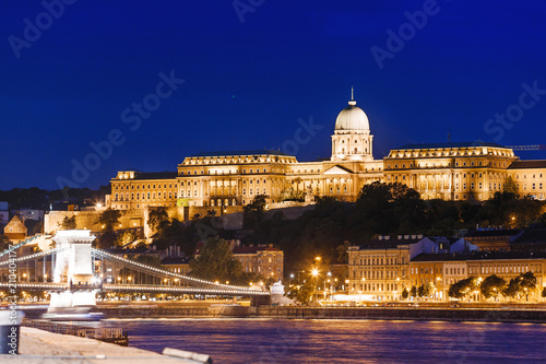 View of Budapest National Gallery and Szechenyi Chain Bridge at night from Danube river