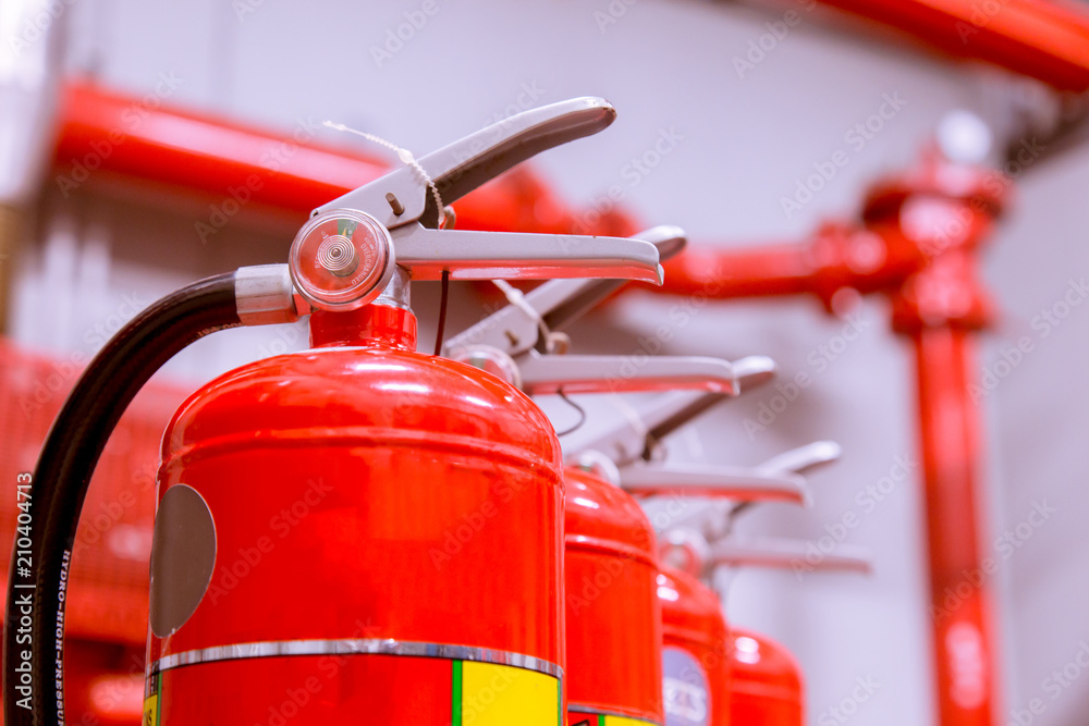 Red tank of fire extinguisher Overview of a powerful industrial fire extinguishing system. Red tank of fire extinguisher Overview of a powerful industrial fire extinguishing system.