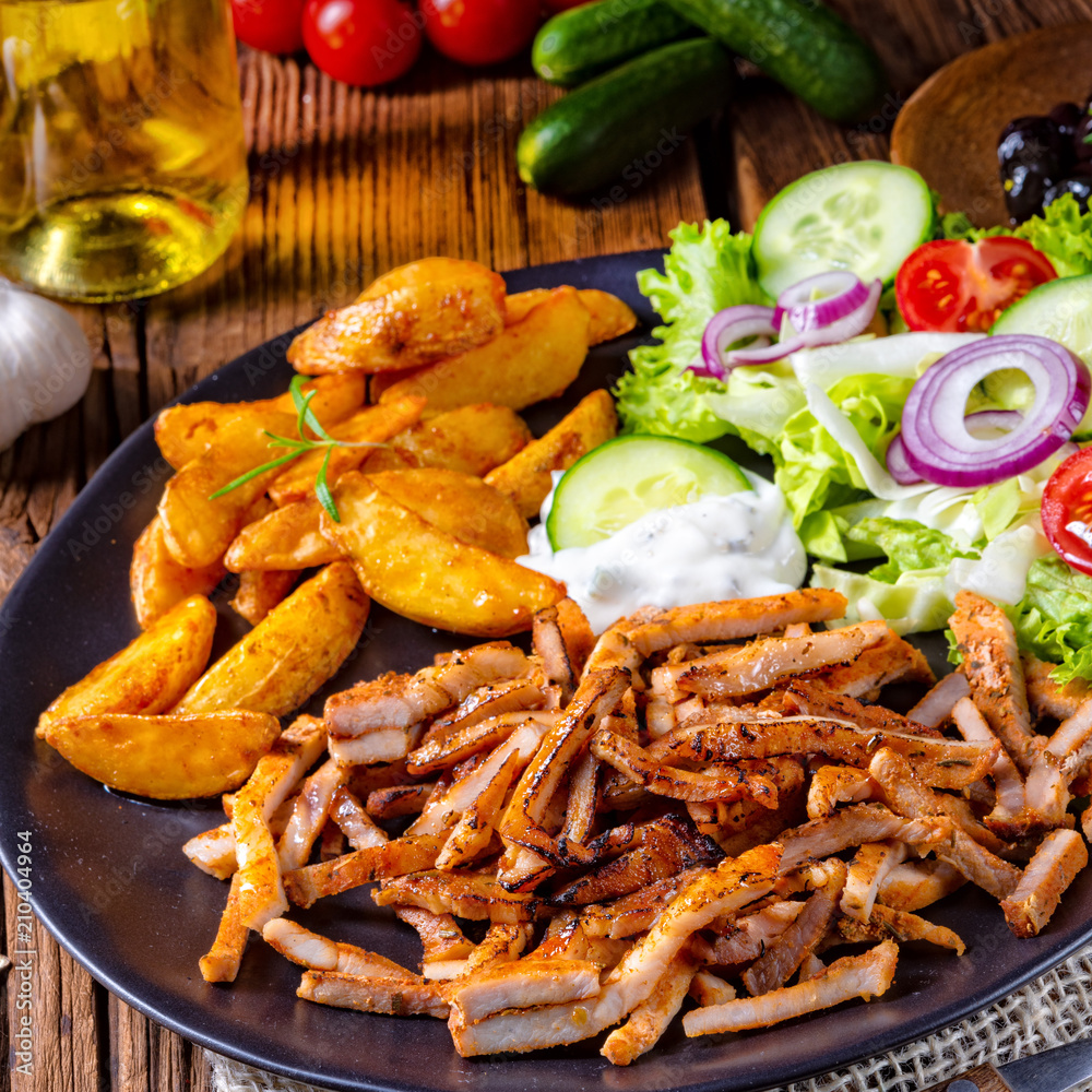 Rustic gyros plate it green salad and potato wedges Rustic gyros plate it green salad and potato wedges