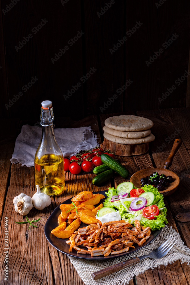 Rustic gyros plate it green salad and potato wedges