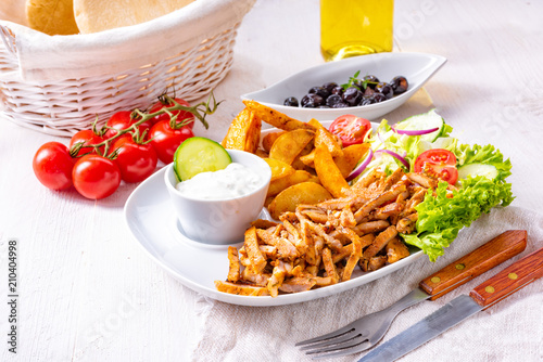 gyros plate it green salad ,olives and potato wedges