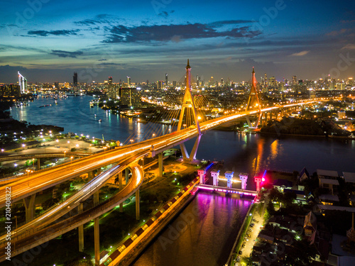 Aerial view of Bhumibol suspension bridge cross over Chao Phraya River in Bangkok city with car on the bridge at sunset sky and clouds in Bangkok Thailand. © Travel man