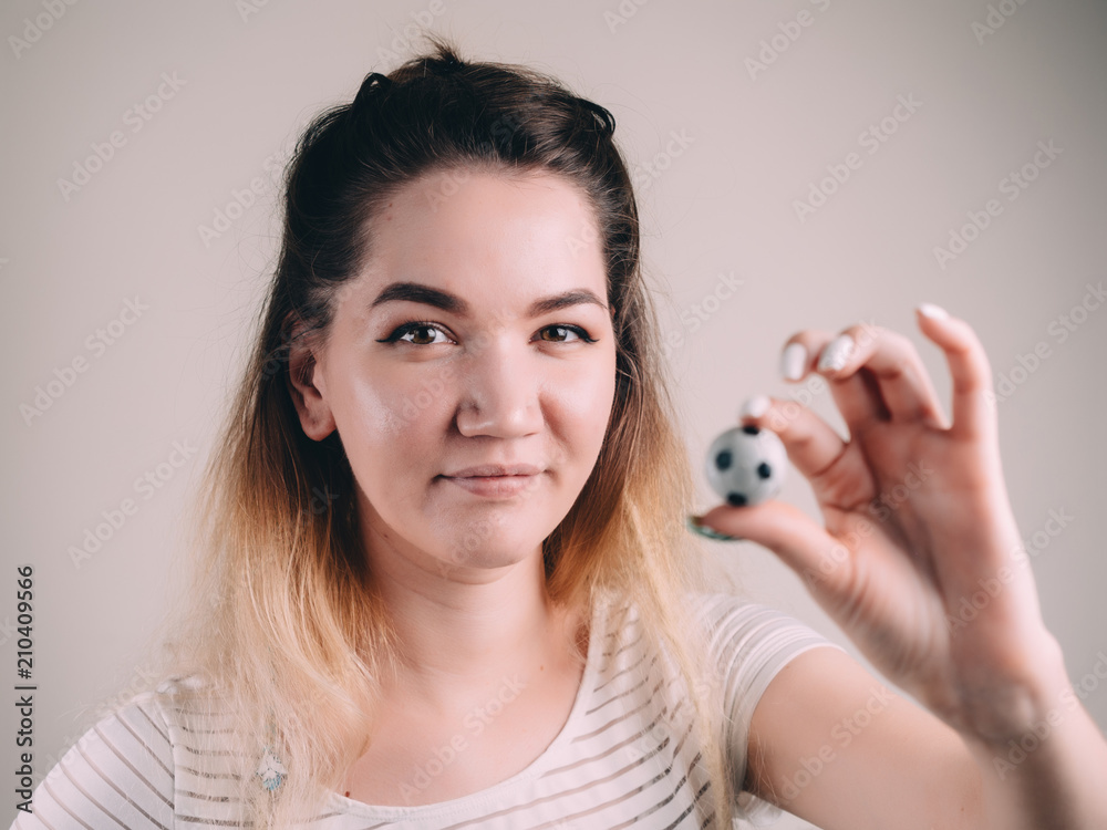Mini table football foosball soccer in girl hands Mini table football foosball soccer in girl hands