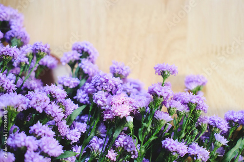 Purple Marguerite daisy flowers blooming decorate on wooden floor background.Felicia amelloides (Blue Marguerite). Ultra violet color of 2018. Copy space