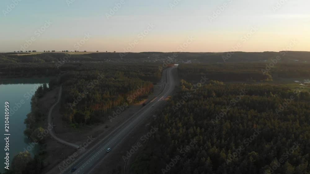 Aerial view of a road with a stream of cars at sunset. Aerial view of a road with a stream of cars at sunset.