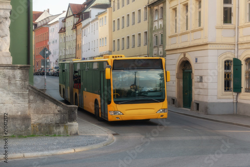 A yellow bus in the city center of Regensburg