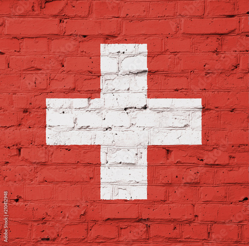 Texture of Switzerland flag of on a pink brick wall.