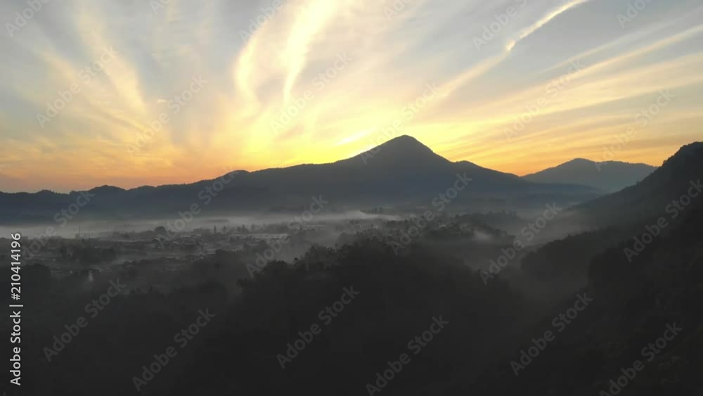 Aerial Clip of Beautiful Golden Sunrise Behind Mountain Overlooking Foggy Valley Aerial Clip of Beautiful Golden Sunrise Behind Mountain Overlooking Foggy Valley