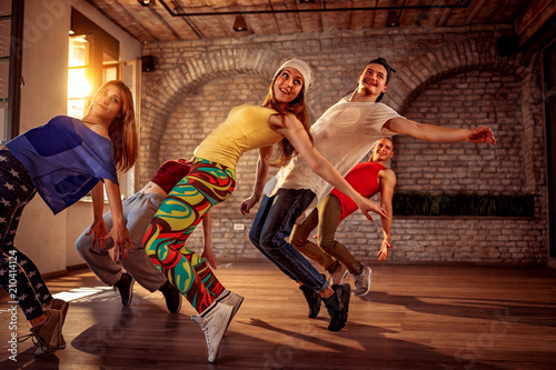 Fototapeta Naklejka Na Ścianę i Meble -  Passion dance team - urban hip hop dancer exercising dance training in studio