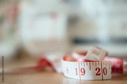 textil meter. ribbon,colorful felt and meter on the background. colorful spools of thread and measuring meter