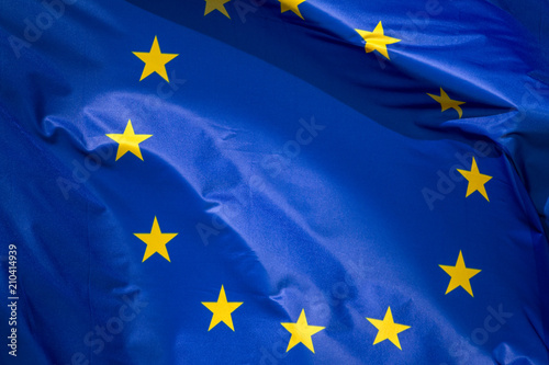 Flag of the European Union which waving in the wind on sunny day, background, close-up