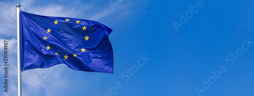Obraz na plátně Flag of the European Union waving in the wind on flagpole against the sky with c