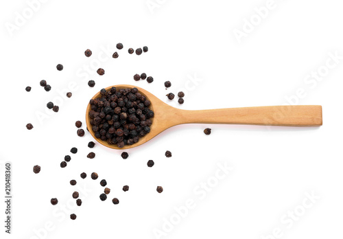 Black pepper in wooden spoon isolated on white background