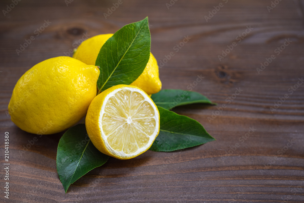 Fresh lemons on wooden background. Copy space Fresh lemons on wooden background. Copy space