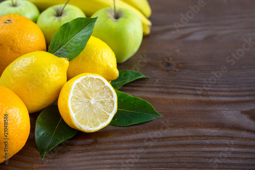 Different healthy fruits on wooden background. Copy space