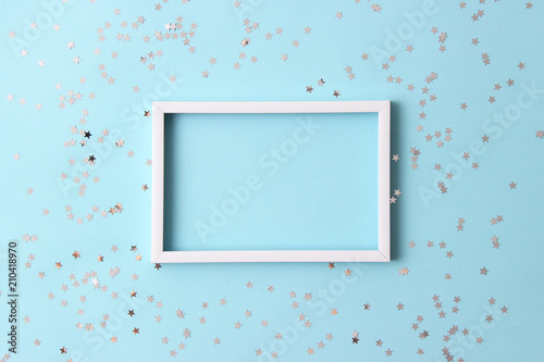 Photography sparkles confetti and frame for inserting text on a colored background top view