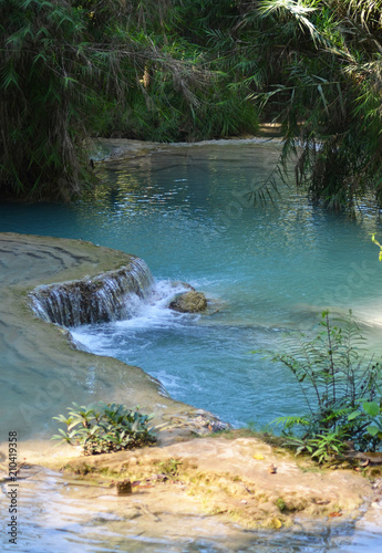 Wallpaper Mural Still blue water in a river, surrounded by a tropical forest. Torontodigital.ca