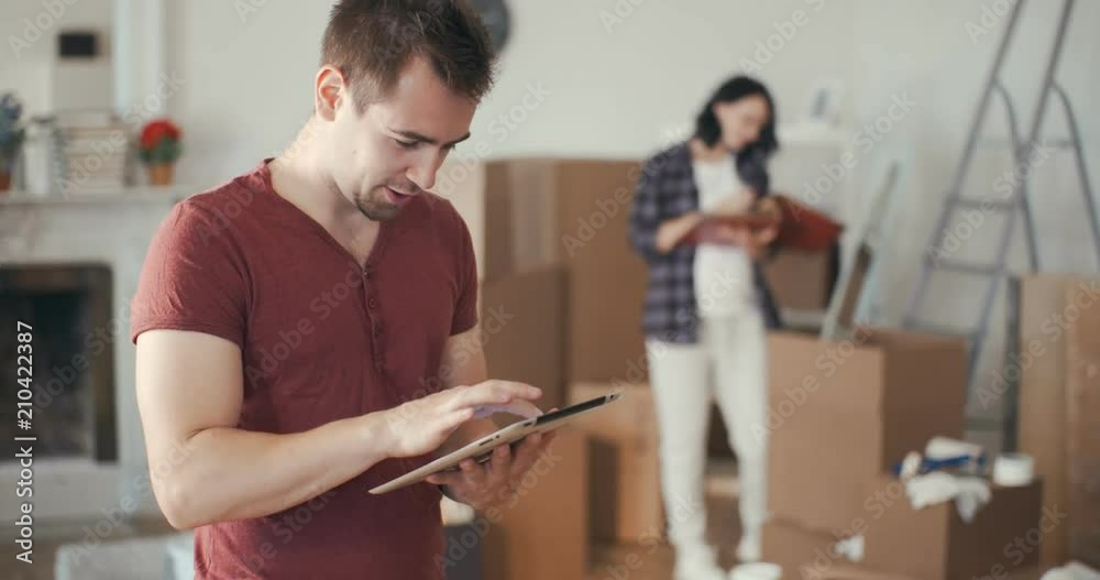 Charming man orders furniture in an online store Charming man orders furniture in an online store