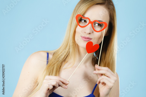 Woman holding carnival accessoies on stick photo