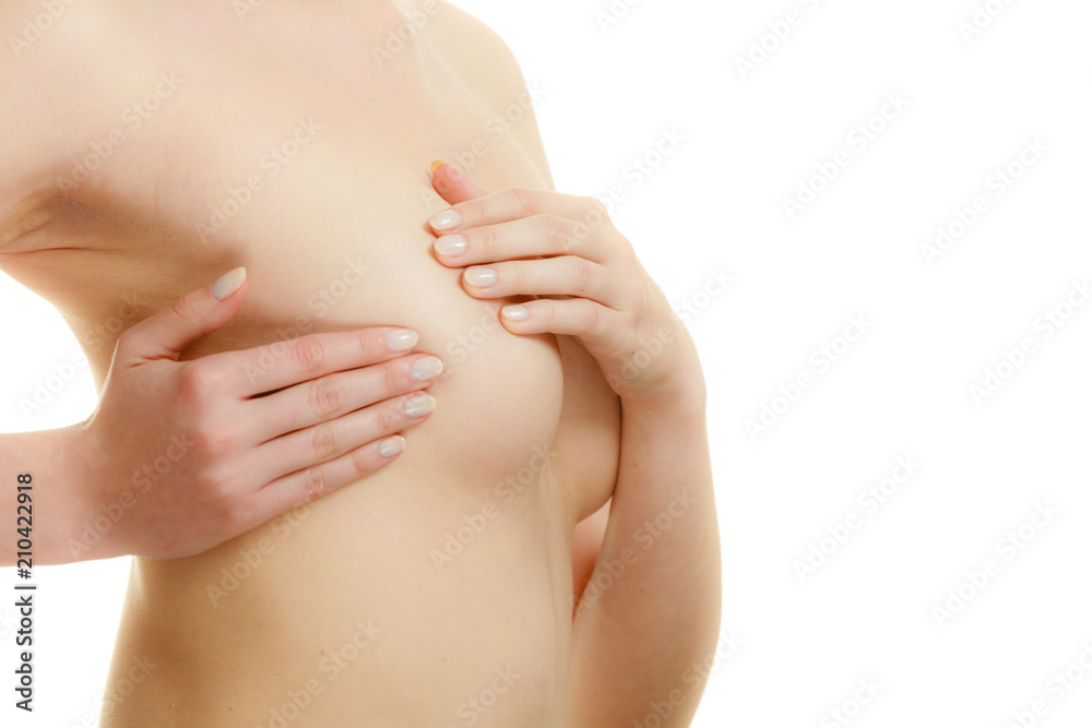 Woman examining her breasts for breast cancer Woman examining her breasts for breast cancer