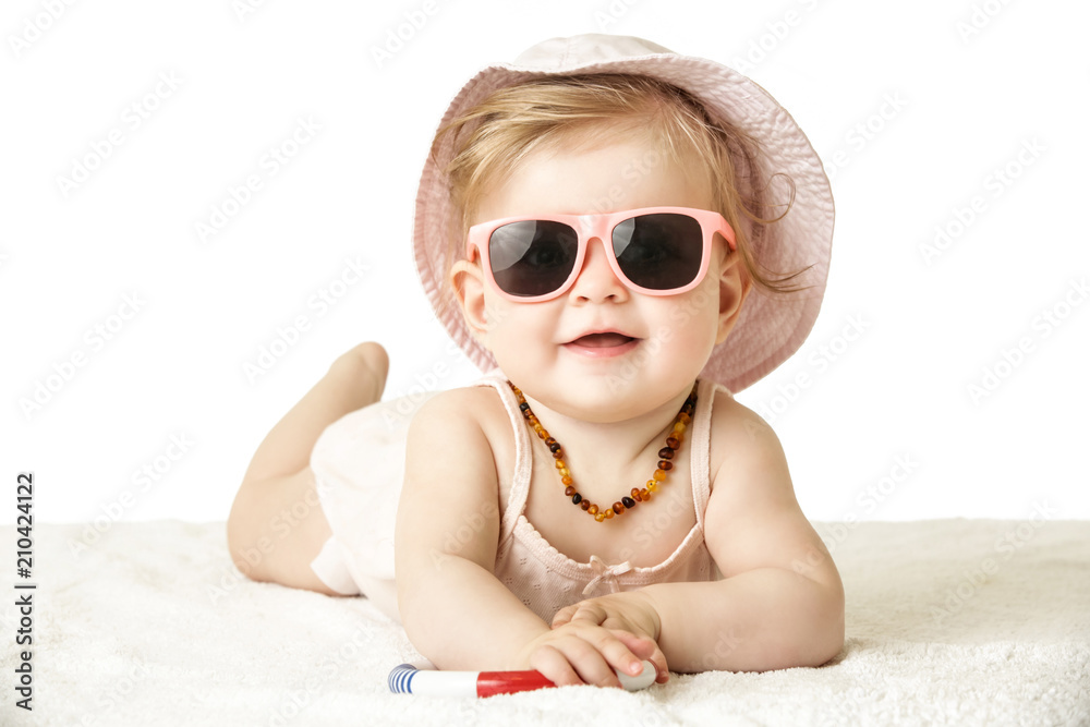 
Studio portrait of adorable baby girl wearing pink plastic sunglasses, isolated on the white background, summer vacation concept - obrazy, fototapety, plakaty 