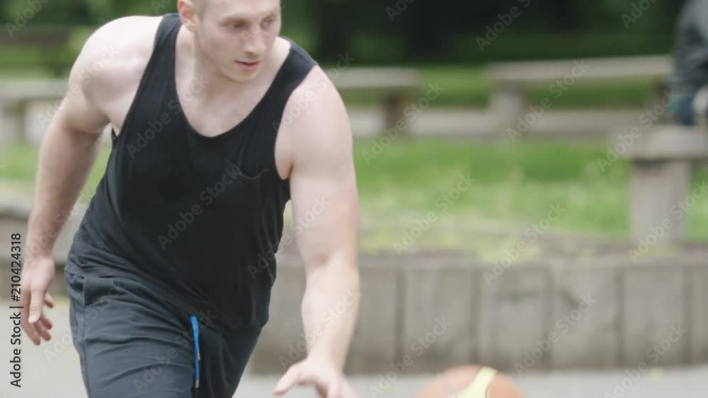 Basketball player tricks his defender, in slow motion Basketball player tricks his defender, in slow motion