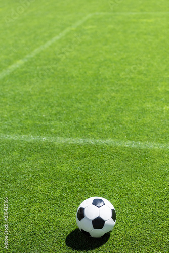high angle view of soccer ball lying on green grass