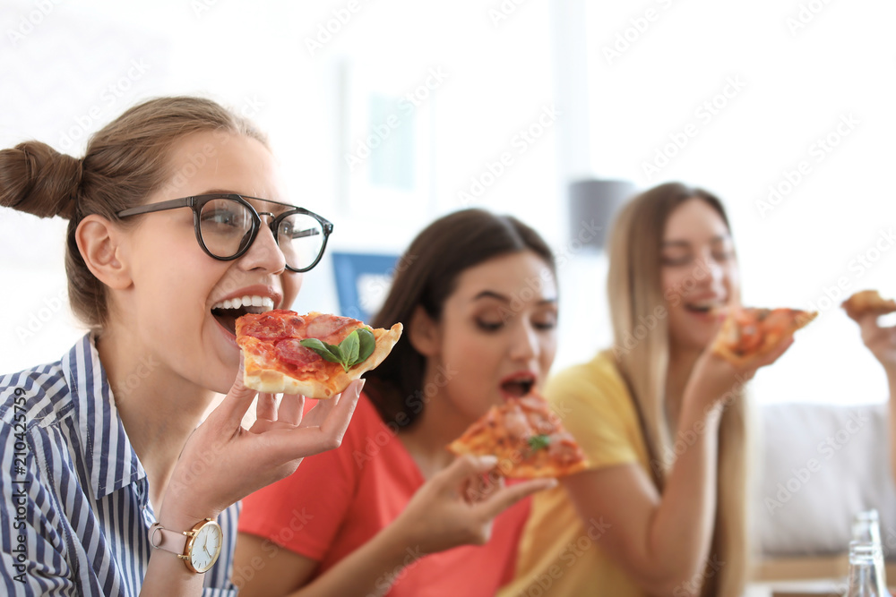 Young people having fun party with delicious pizza indoors Young people having fun party with delicious pizza indoors