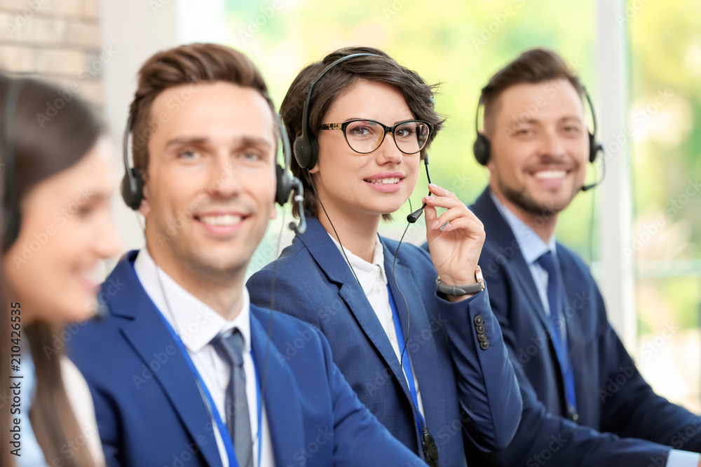 Technical support operators with headsets at workplace Technical support operators with headsets at workplace