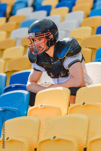 handsome young american football player sitting on tribunes at sports stadium © LIGHTFIELD STUDIOS