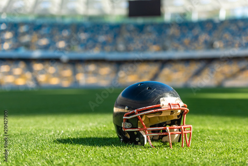 close-up shot of american football helmet lying on green grass of stadium © LIGHTFIELD STUDIOS