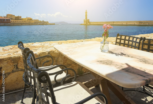 Cafe with marble tables on sea coast in Chania  Crete island  Greece. Selective focus