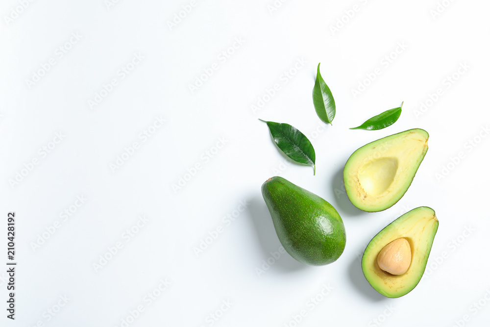 Composition with ripe fresh avocados on white background Composition with ripe fresh avocados on white background
