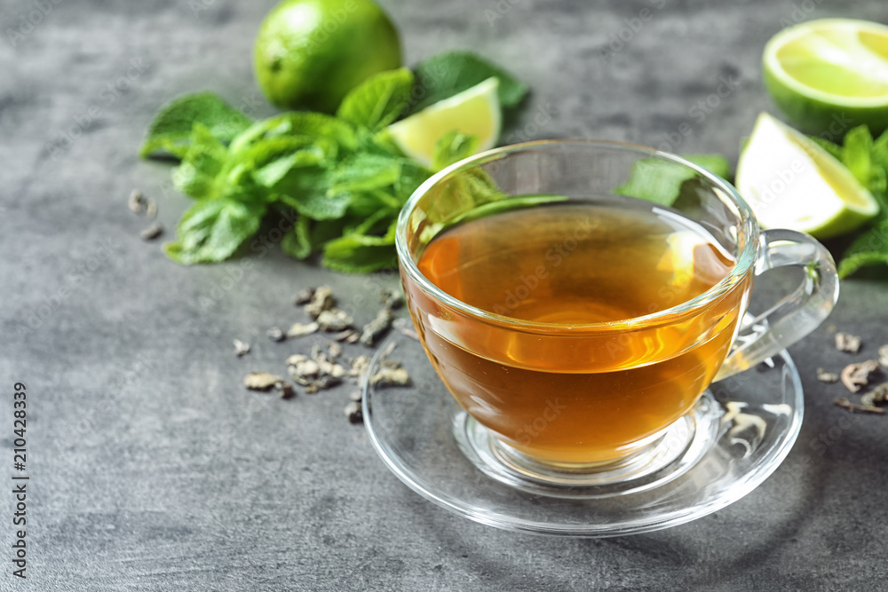 Cup with hot aromatic mint tea on table Cup with hot aromatic mint tea on table