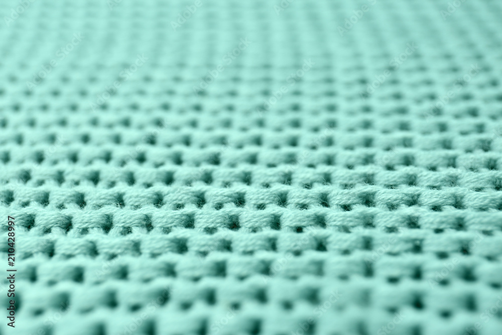 Naklejka premium Knitted mint blue fabric texture as background, closeup
