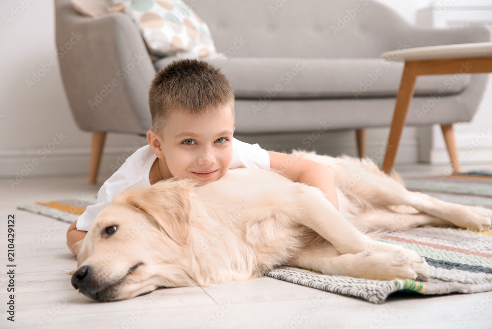 Cute little child with his pet on floor at home Cute little child with his pet on floor at home