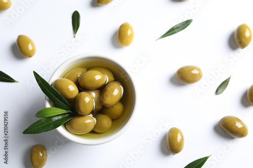 Bild auf Leinwand Flat lay composition with fresh olives in oil on white background