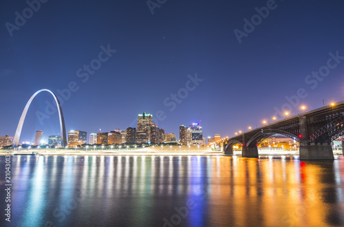 st. louis skyscraper at night with reflection in river,st. louis,missouri,usa.