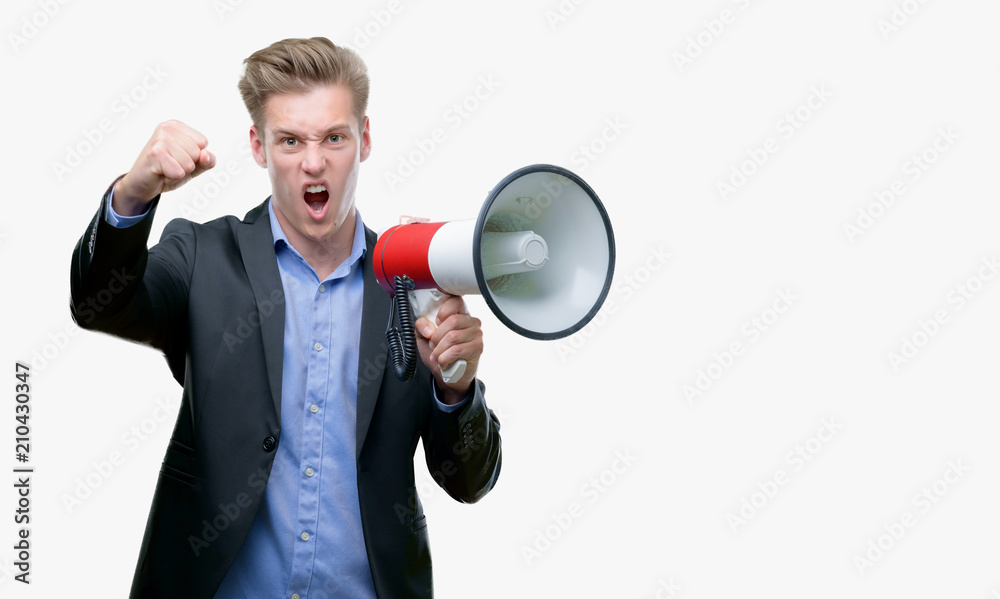 Young handsome blond man holding a megaphone annoyed and frustrated shouting with anger, crazy and yelling with raised hand, anger concept Young handsome blond man holding a megaphone annoyed and frustrated shouting with anger, crazy and yelling with raised hand, anger concept
