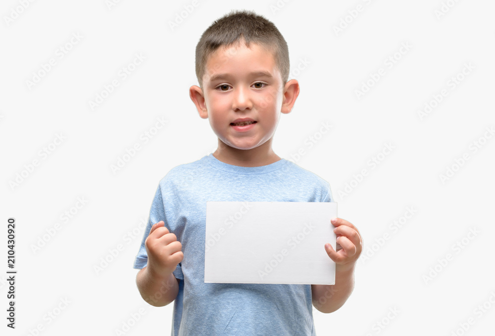 Dark haired little child holding a blank card screaming proud and celebrating victory and success very excited, cheering emotion Dark haired little child holding a blank card screaming proud and celebrating victory and success very excited, cheering emotion