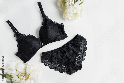 Classic black underwear set on the white background with flowers photo